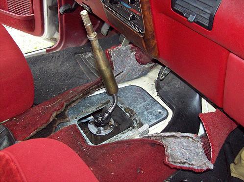 Pull the carpet back to expose the floor plate