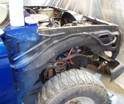 Harness for power windows and locks attached to inner fender