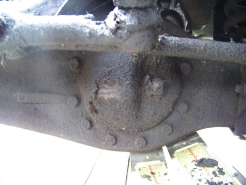 Front axle covered in grease, oil and dirt